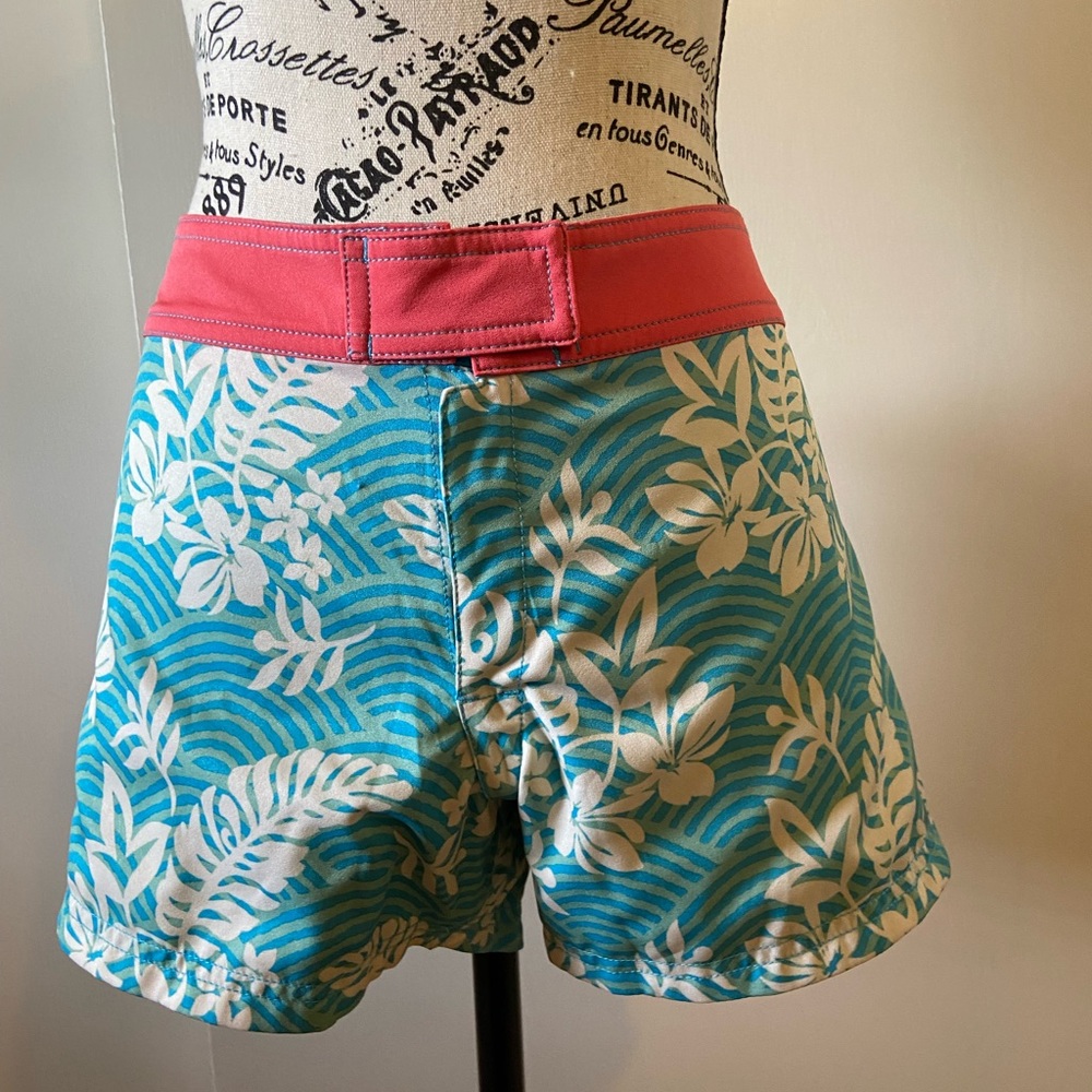 NWOT Reversible swim shorts turquoise/floral and pink. Very cute never worn